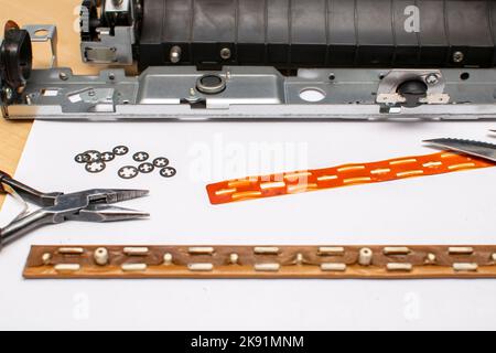 locking rings and spare parts lying next to the tools on a sheet of paper Stock Photo
