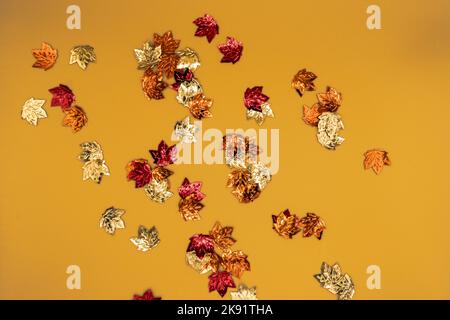 Shiny little leaves on a yellow background. Stock Photo
