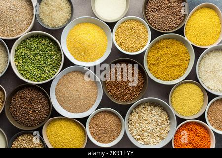 Various grain cereals in bowls on a light background, top view Stock Photo