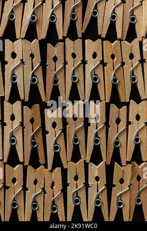Row wood clothespins on black background Stock Photo