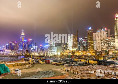 VICTORIA, HONGKONG - JAN 7, 2010: view during Hong Kong Harbor Laser Show to Skyline of Victoria and a construction site by night in Victoria, Hongkon Stock Photo