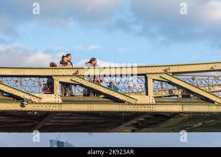 FRANKFURT, GERMANY - FEB 22, 2015: people at the Eiserner Steg - old iron bridge over the river Main in Frankfurt. The Eiserner Steg is a pedestrian b Stock Photo