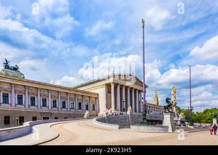 VIENNA, AUSTRIA - APR 27, 2015: people relax at fountain of  The Austrian Parliament Building (Parlamentsgebaude) in Vienna. The building was complete Stock Photo