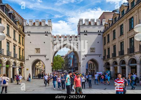 Munich, Germany - MAY 27, 2016: People walking along through the Karlstor gate in Munich. Stock Photo