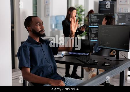 Software developer analysing ar hologram to work on html code, using holographic database interface with augmented reality. Cloud computing program with terminal window in big data office. Stock Photo