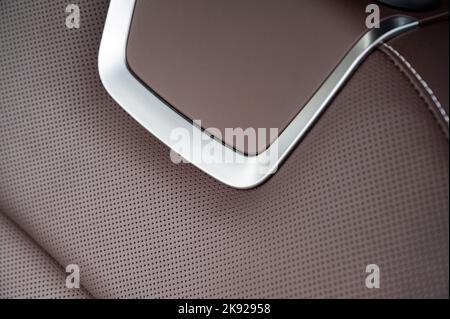 Close up of brown red perforated leather new sport car seat Stock Photo