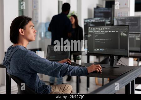 App engineer programming html server code algorithm on computer, typing data info in it agency office. Database programer working on new user interface with online system to create algorithm. Stock Photo