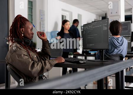 Software developer thinking at it ideas trying to write code and create new interface in software company. Web developer programming server database in busy artificial intelligence developing agency. Stock Photo
