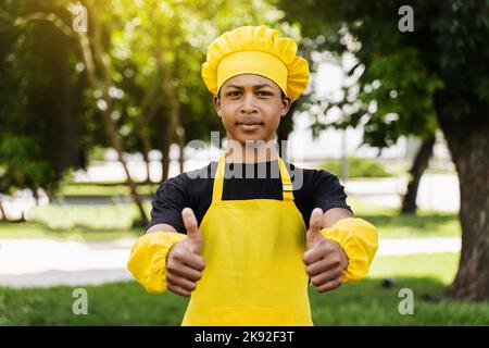 African children cooks in chefs hat and yellow uniforms grimacing and  showing tongue each others. African teenager and black girl have fun and  cook fo Stock Photo - Alamy