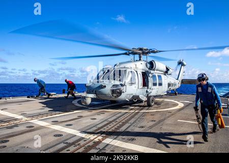 PHILIPPINE SEA (Oct. 22, 2022) Rear Adm. Buzz Donnelly speaks to the ...