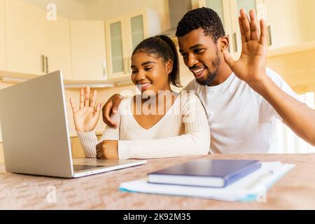 happy couple calling by video chat to family from their new apartment Stock Photo