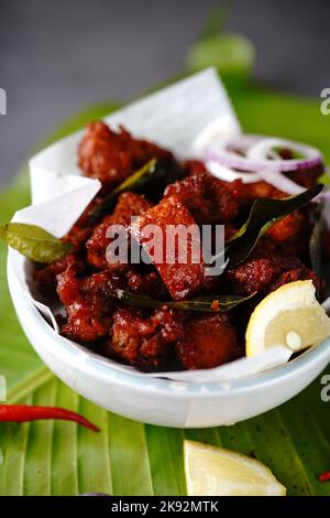 Homemade chicken 65 or chilli chicken fry served in a bowl, selective focus Stock Photo