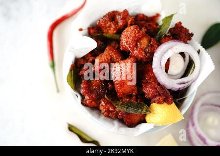 Homemade chicken 65 or chilli chicken fry served in a bowl, selective focus Stock Photo