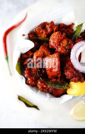 Homemade chicken 65 or chilli chicken fry served in a bowl, selective focus Stock Photo