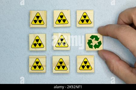 Reuse, reduce, recycle concept background. Recycle symbol made from old clothing on yellow background. Top view or flat lay. Stock Photo