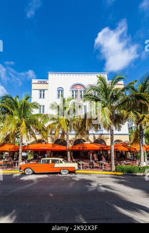 MIAMI, USA - AUG 5, 2013: The Art Deco Edison Hotel and a classic oldsmobile car on Ocean Drive, South Beach, Miami, USA. Classic cars are allowed to Stock Photo
