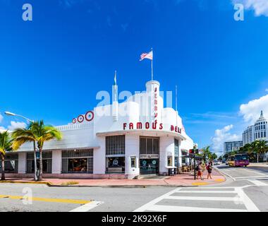 MIAMI, USA - AUG 5, 2013: people go to Jerrys famous Deli at the Main street in Miami, USA. Jerry Famous Deli was originally built as Hoffmans Cafeter Stock Photo