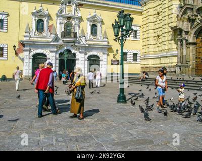 LIMA, PERU - JAN 15, 2015:  woman dressed with traditional clothing sells handcraft in front of San Francisco church in Lima, Peru. Stock Photo