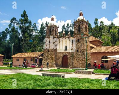 RAQCHI, PERU - JAN 19, 2015: people visit the church San Pedro de Cacha in Raqchi, Peru. The church of Raqchi is placed near the incan temple of Wirac Stock Photo