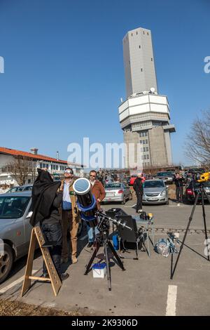 SCHMITTEN, GERMANY - MAR 20, 2014: radio and TV station at Mount Grosser Feldberg  in Schmitten, Germany. People watch the partial eclipse. Stock Photo