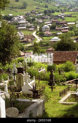 Village and local cemetery in Harghita County, Romania, approx. 2003 Stock Photo