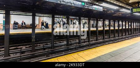 NEW YORK, USA - OCT 20, 2015: People wait at subway station Wall street in New York. With 1.75 billion annual ridership, NYC Subway is the 7th busiest Stock Photo