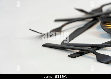 black metal forks and spoons on a white background, mexico Stock Photo