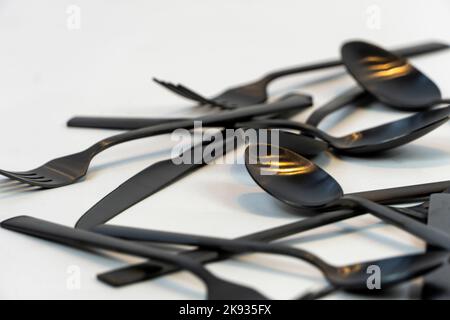 black metal forks and spoons on a white background, mexico Stock Photo