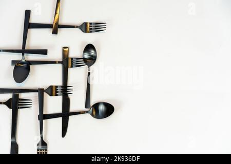 black metal Dinnerware Cutlery Utensils, Forks Knives, Spoons on Gray Background mexcio Stock Photo