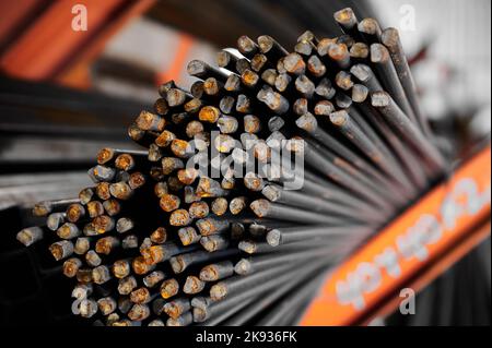 Thin metal rods bunch in cold plant warehouse macro view Stock