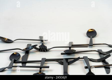 black metal forks and spoons on a white background, mexico Stock Photo