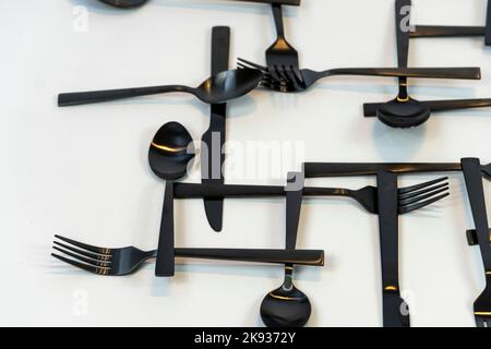 black metal forks and spoons on a white background, mexico Stock Photo