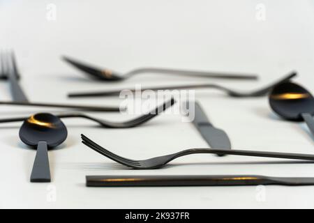 black metal forks and spoons on a white background, mexico Stock Photo