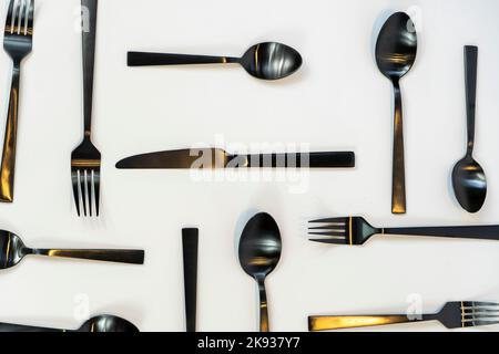 black metal forks and spoons on a white background, mexico Stock Photo