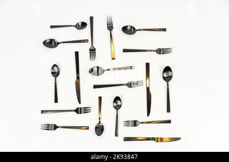 black metal forks and spoons on a white background, mexico Stock Photo