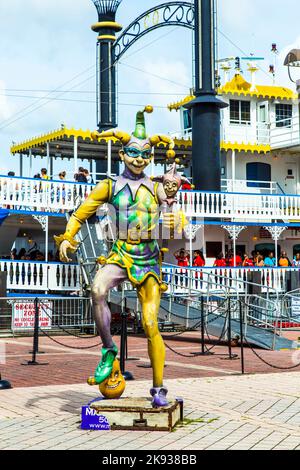 NEW ORLEANS - JULY 16, 2013: people at the creole Queen steam boat in New Orleans, USA. The Jester, symbol for Mardi Gras, stands in front. Stock Photo