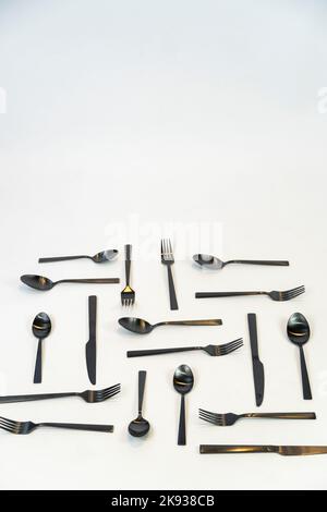 black metal Dinnerware Cutlery Utensils, Forks Knives, Spoons on Gray Background mexcio Stock Photo