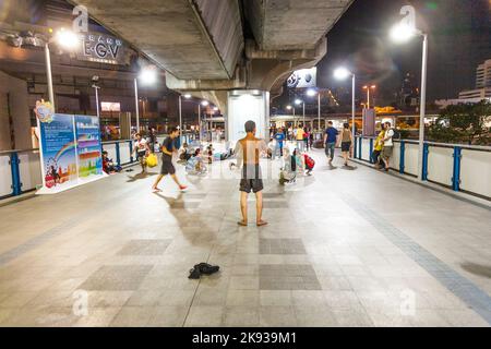 BANGKOK, THAILAND - DEC 23, 2009: teens perform a streetdance performance at the train station in Bangkok, Thailand by night. Street dancing is very p Stock Photo