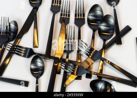black metal forks and spoons on a white background, mexico Stock Photo