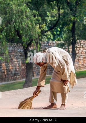 DELHI, INDIA - NOV 11, 2011: workers at Humayun's Tomb cleans the yard in Delhi, India. They also get alms by religious people. The tomb was built by Stock Photo