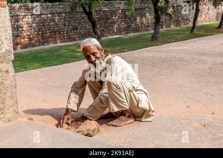 DELHI, INDIA - NOV 11, 2011: workers at Humayun's Tomb cleans the yard in Delhi, India. They also get alms by religious people. The tomb was built by Stock Photo