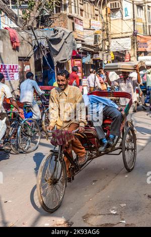 DELHI, INDIA - NOVEMBER 11, 2011: Cycle rickshaws with passenger in the streets in Delhi, India. Cycle rickshaws were introduced in the 1940's and hav Stock Photo