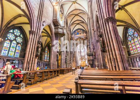 FREIBURG, GERMANY - JULY 4, 2013: people visit the minster in Freiburg, Germany.  The last duke of Zaehringen had started the building around 1200 in Stock Photo