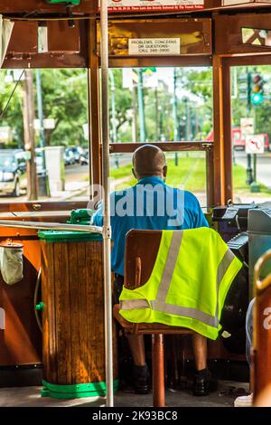 NEW ORLEANS - JULY 16, 2013:  conductor in the famous old Street car St. Charles line in New Orleans, USA. It is the oldest continually operating stre Stock Photo