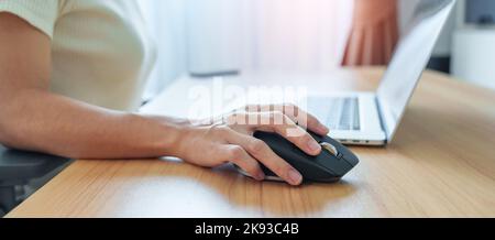 woman hand using ergonomic vertical mouse during working on Adjustable desk, prevention wrist pain. De Quervain s tenosynovitis, Intersection Symptom, Stock Photo