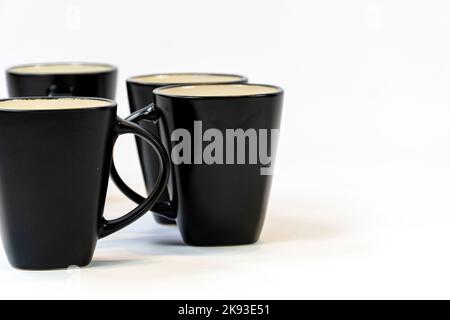 Different clean plates in dish drying rack on kitchen counter Stock Photo