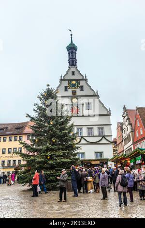 ROTHENBURG, GERMANY - DEC 2, 2014: Tourists at the market place of Rothenburg ob der Tauber, Germany. The medieval town attracts over 2 million visito Stock Photo