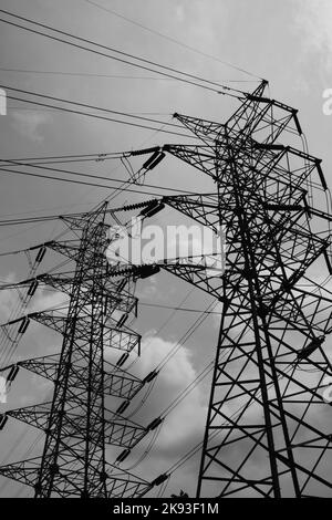 Black and white photo, Monochrome photo of a power supply tower that divides agricultural land in Cicalengka - Indonesia Stock Photo