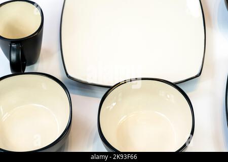 white ceramics bowl isolated on white background. plates and bowls arranged black color the frets Stock Photo