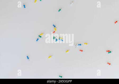 Push pins scattered on white background Stock Photo